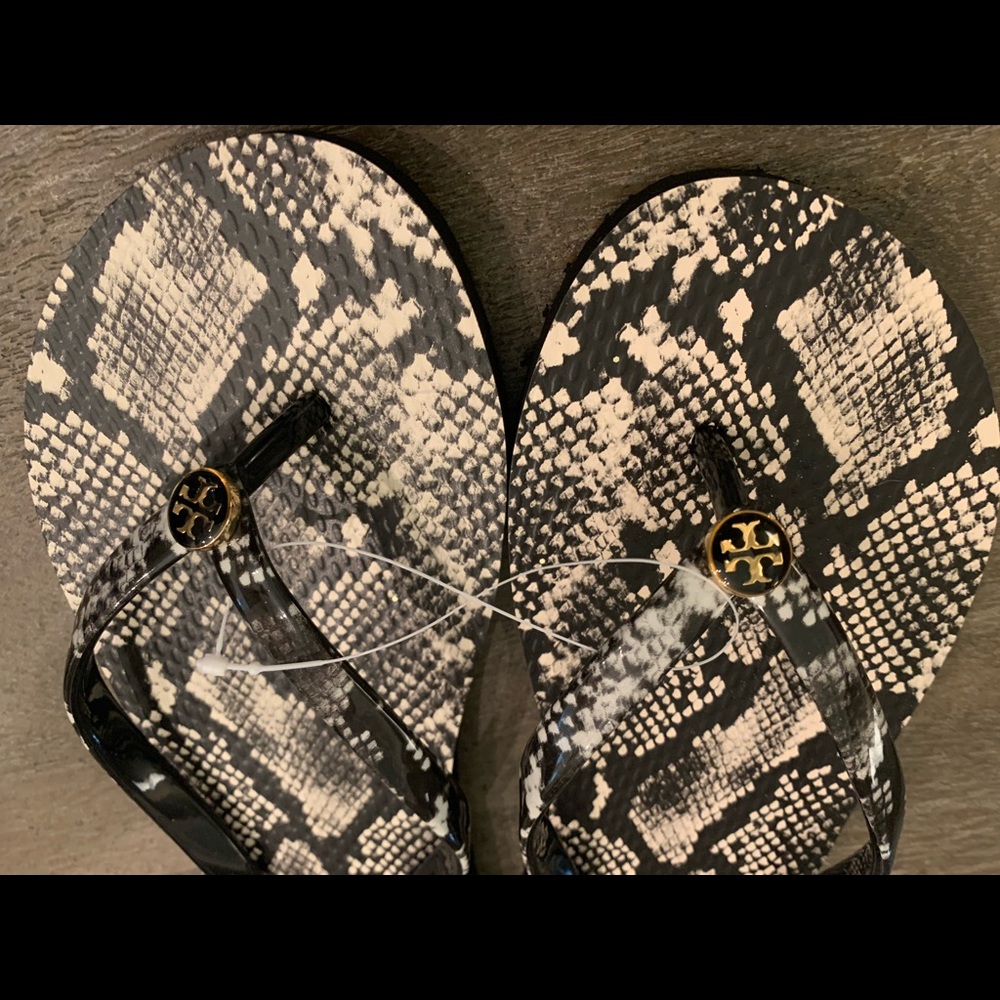 Tory Burch snakeskin flip flops. NWOT but still have the plastic band connector.